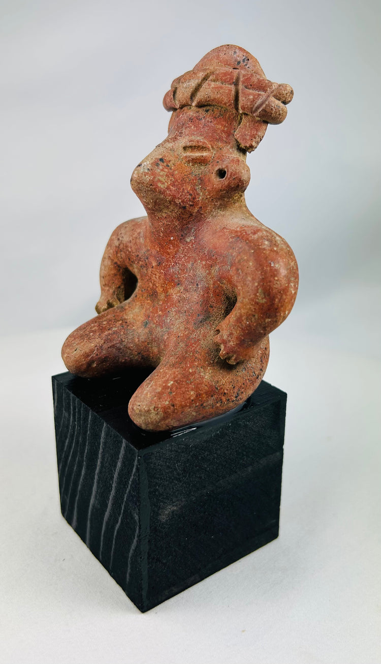 West Mexican ceramic tomb figure with pierced ears and elaborate headdress