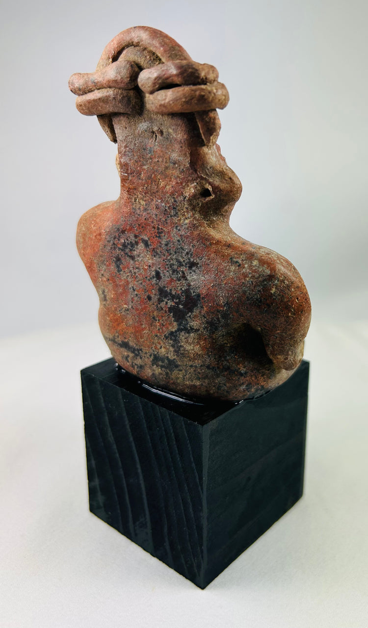 Pre-Columbian red slip figurine displayed on custom museum-style stand