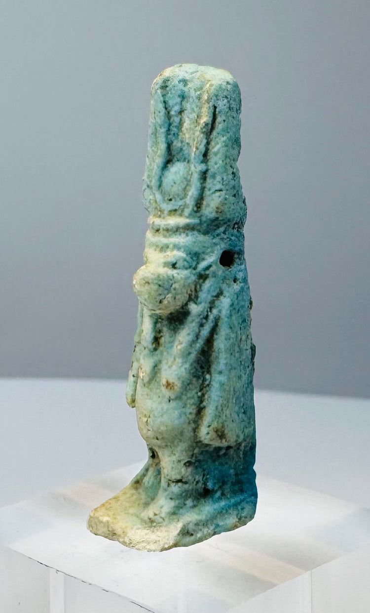 Detail of the transverse suspension hole beneath the headdress of a Taweret amulet