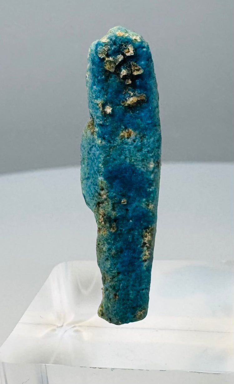 Ancient faience amulet depicting a standing lioness-headed deity on an integral base
