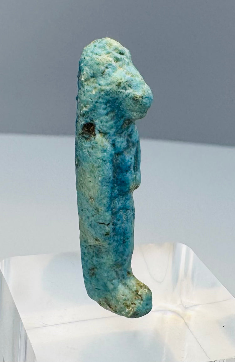 Small mold-formed Egyptian faience figure with burial deposits and turquoise glaze