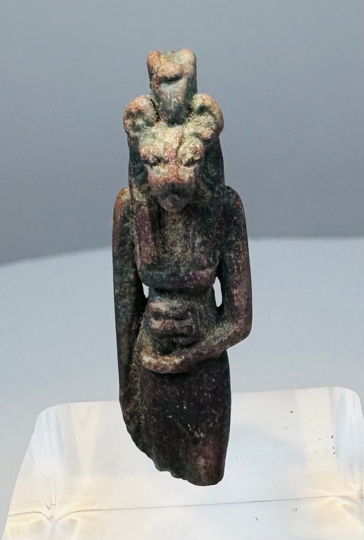 Opposite side view of an Egyptian feline goddess amulet with an elongated standing form