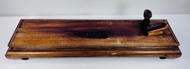 Custom-fitted reddish-brown hardwood display pedestal with moulded borders and scrolling feet