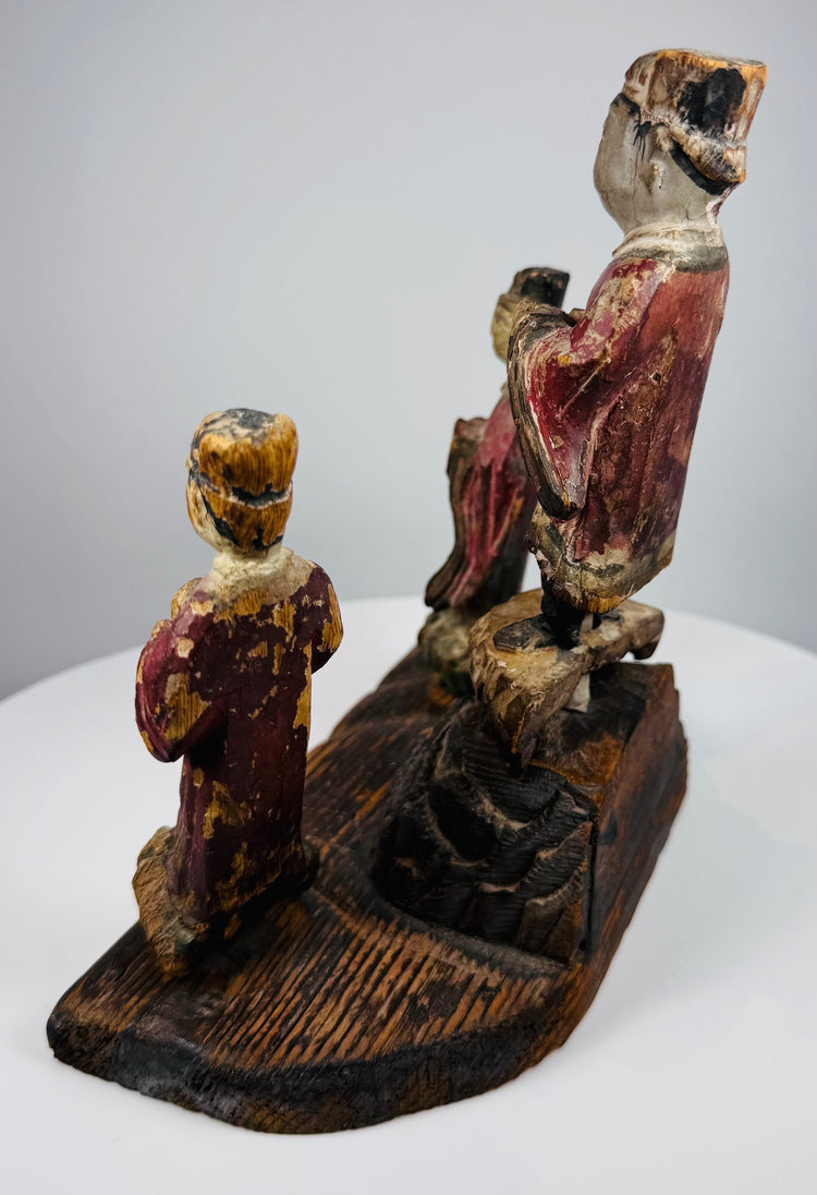 Surviving red, green, ochre, black, cream and brown pigments across the wooden devotional figures