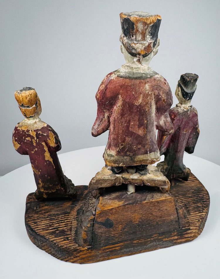 Painted facial features, moustache, beard and ceremonial clothing of the elevated central official