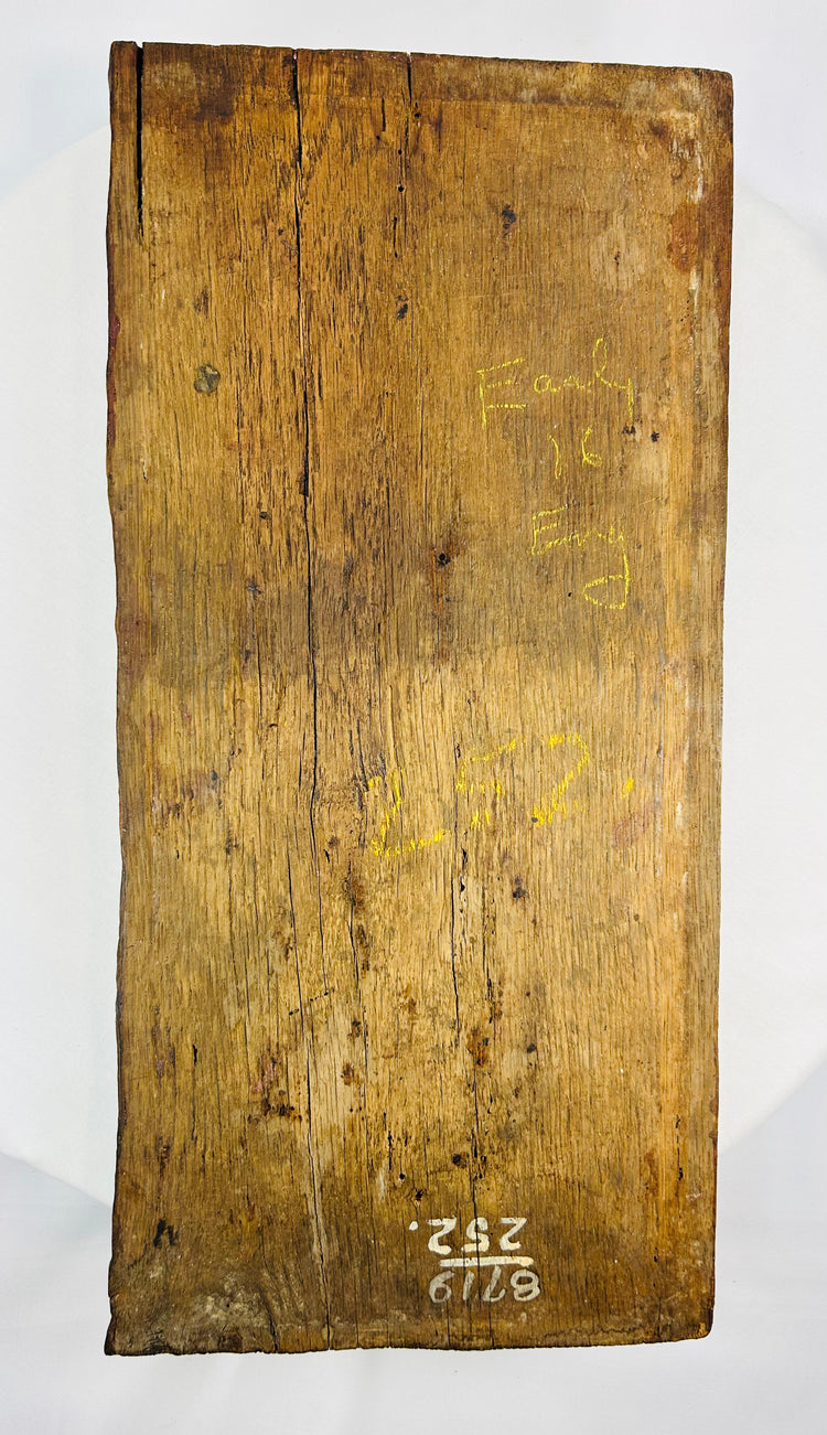 Back view of european 1500s carved oak panel displaying pointed arches and decorative fluted carving