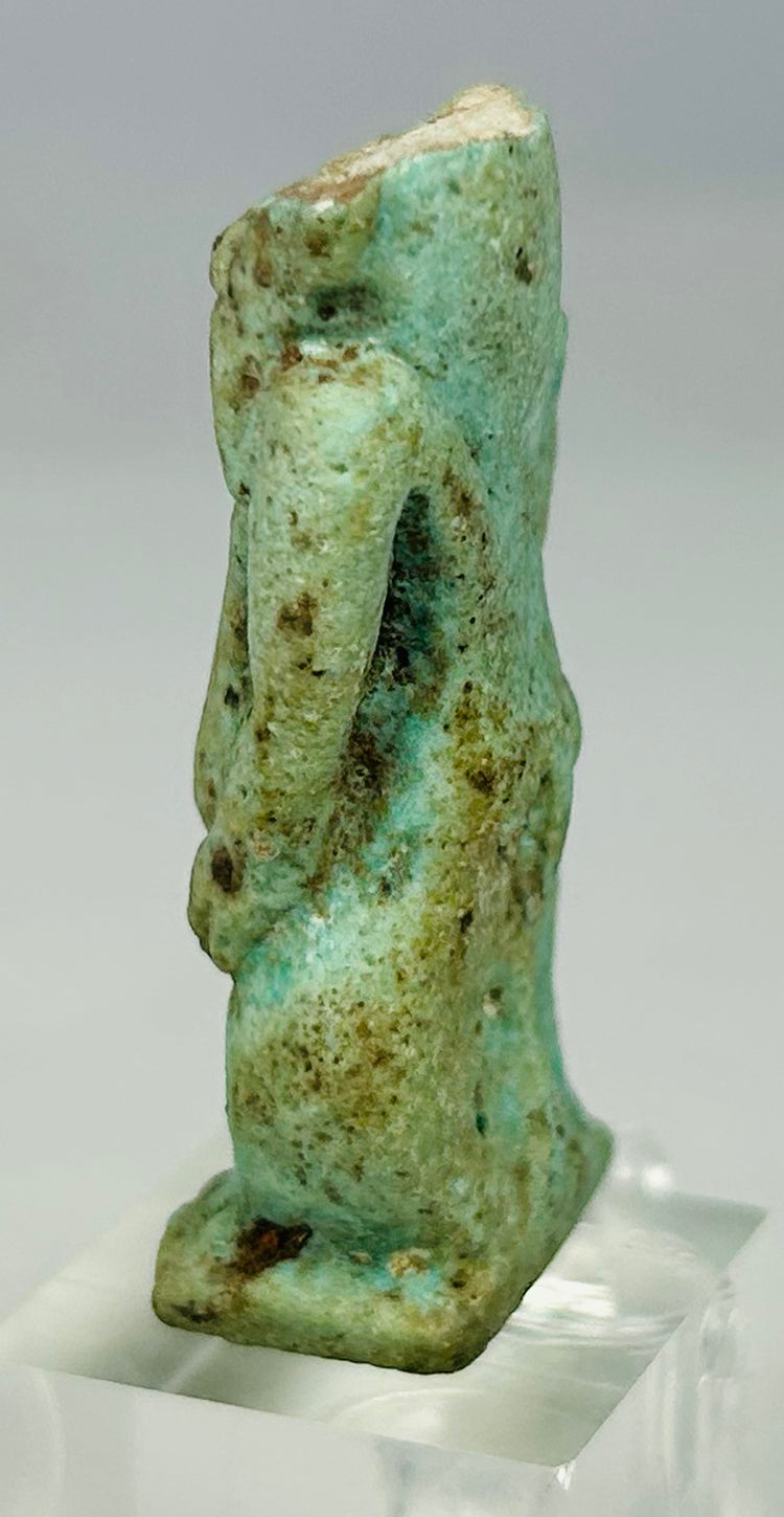 Side view of Late Period Bes amulet highlighting squat stance and carved body form