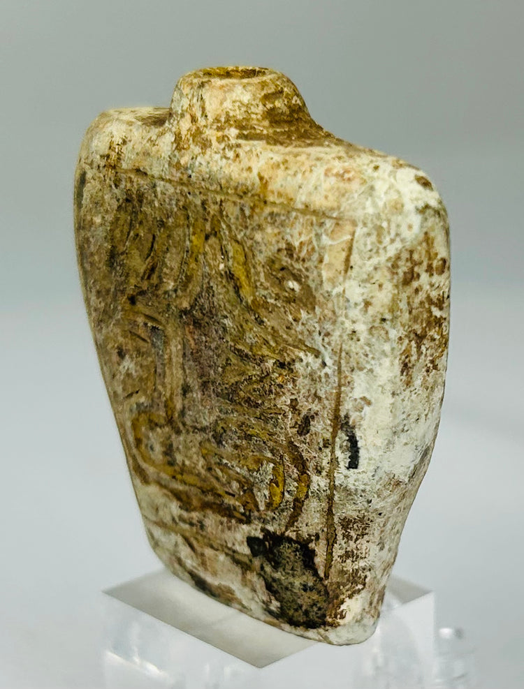 Double-sided carved stone amulet vessel with protective symbolic decoration