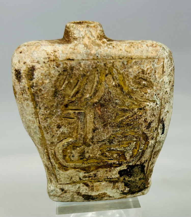 Ancient stone container amulet likely used for oil or pigment with decorative carvings