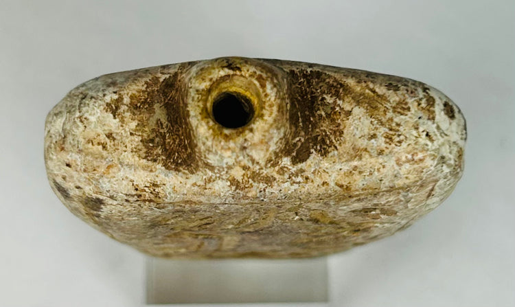 Ancient Mediterranean amulet flask relic with symbolic figures and protective meaning