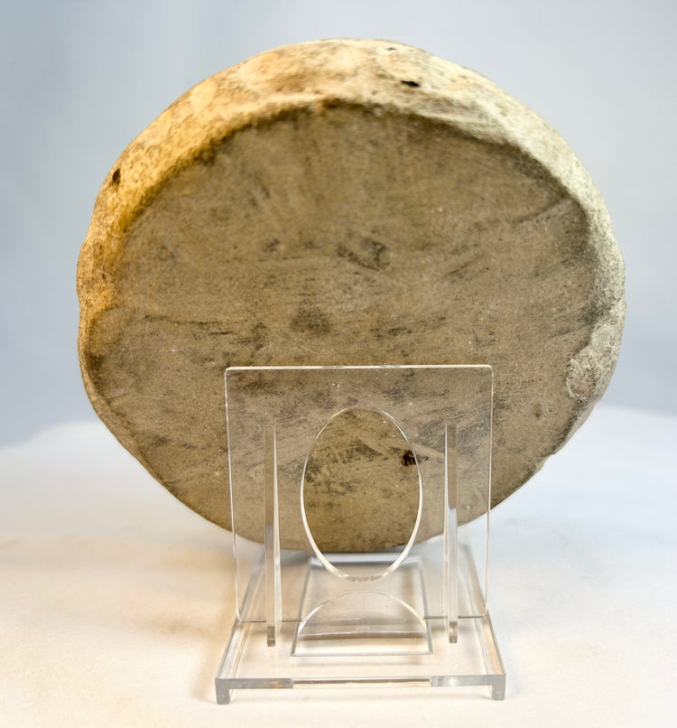 Central back view of carved stone sculpture showing smooth weathered surface