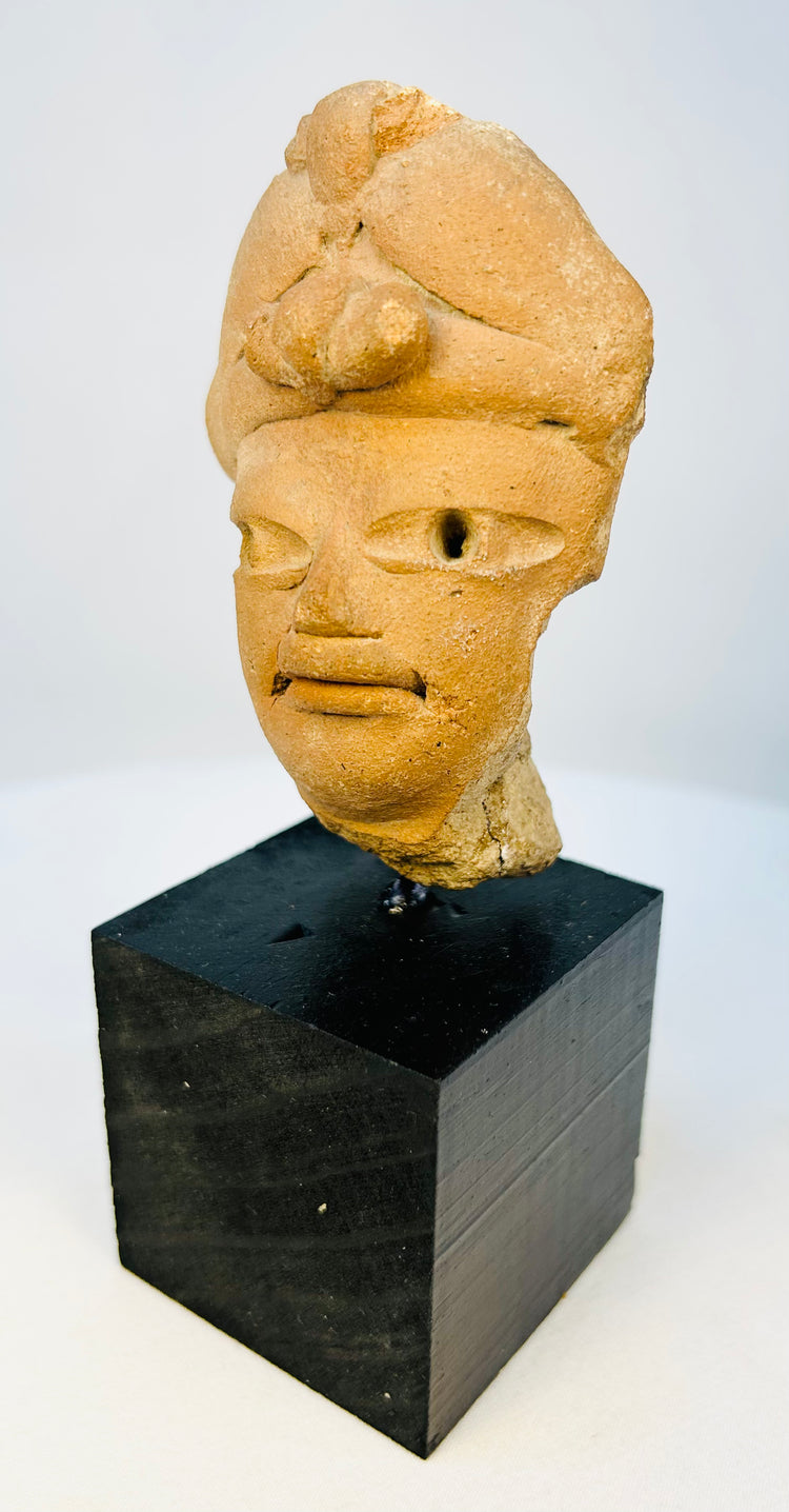 Side profile of ancient West Mexican terracotta head with visible age wear