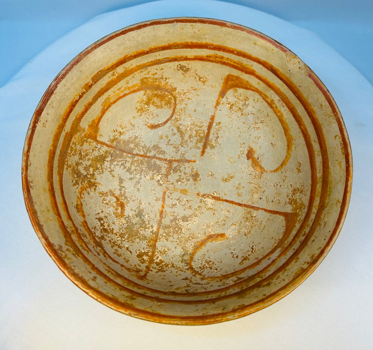 Ancient Mesoamerican ceramic bowl showing interior spiral and linear motifs