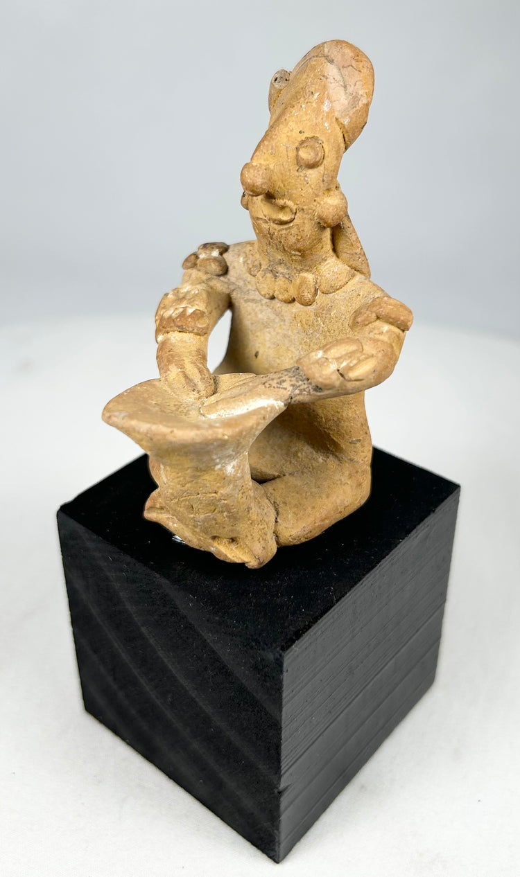 Pre-Columbian Nayarit or Jalisco terracotta shaft tomb musician figurine with cross-legged posture and ceremonial adornments
