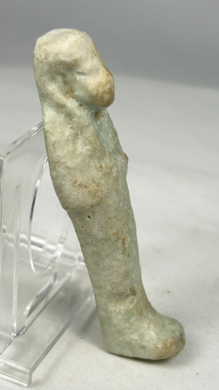 Blue-green faience ushabti with burial patina and encrustations