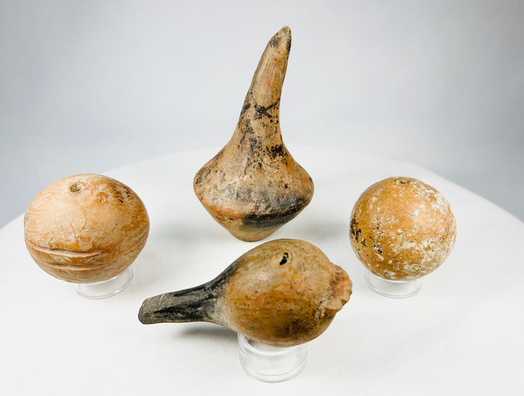 Ancient Pre-Columbian ceramic ritual rattles from Mesoamerica, hand-formed with internal sound pellets.