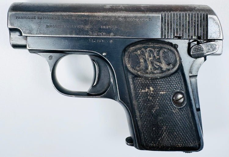 Early 20th-century FN Browning Model 1906 with silvered finish wear, slide serrations, and an FN grip monogram.