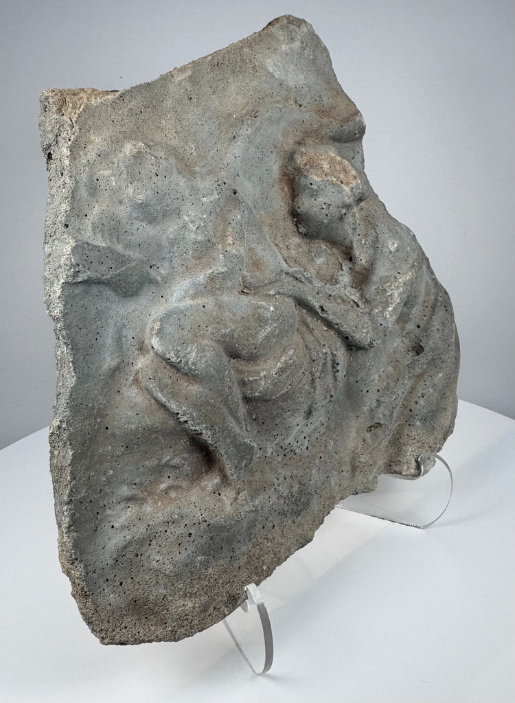 Ancient Roman volcanic stone carving with eroded figural composition, porous surface and mineral deposits