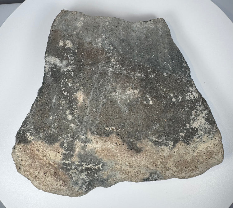 Carved Roman volcanic tuff relief fragment displaying porous stone grain, sculptural erosion and mineral encrustation