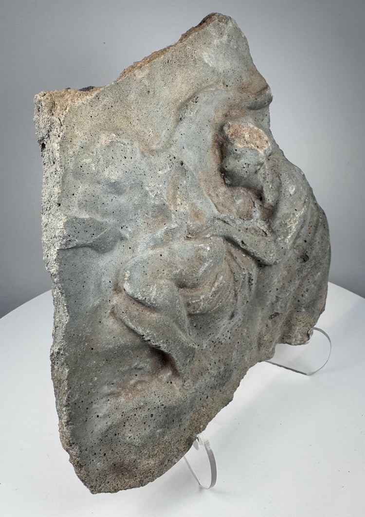 Ancient Roman figural stone fragment with weathered relief carving and gray volcanic tuff surface, circa 1st century BCE–2nd century CE