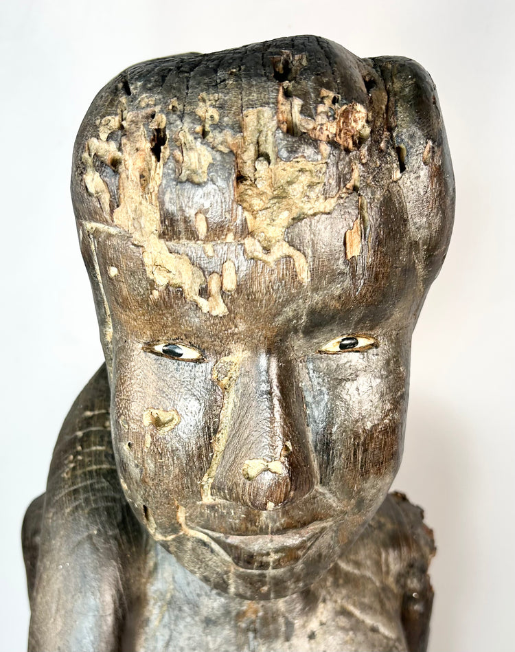 Indonesian Dayak wooden sculpture with inset eyes and ritual wear