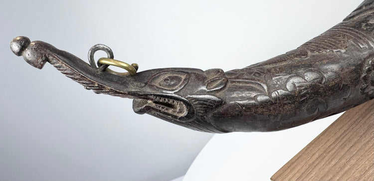 Front opening of an antique Tibetan ceremonial horn showing the hollow carved interior and curved mouthpiece end.