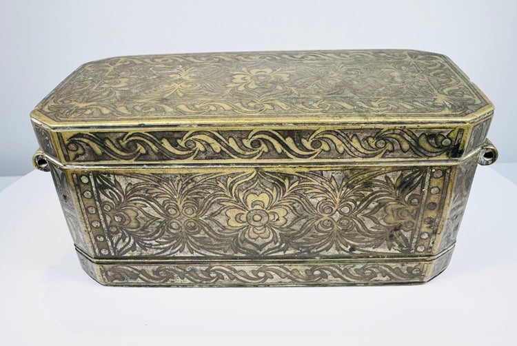 Late 18th to early 19th-century Philippine betel nut box with intricate brass floral inlay and aged mixed-metal surface.