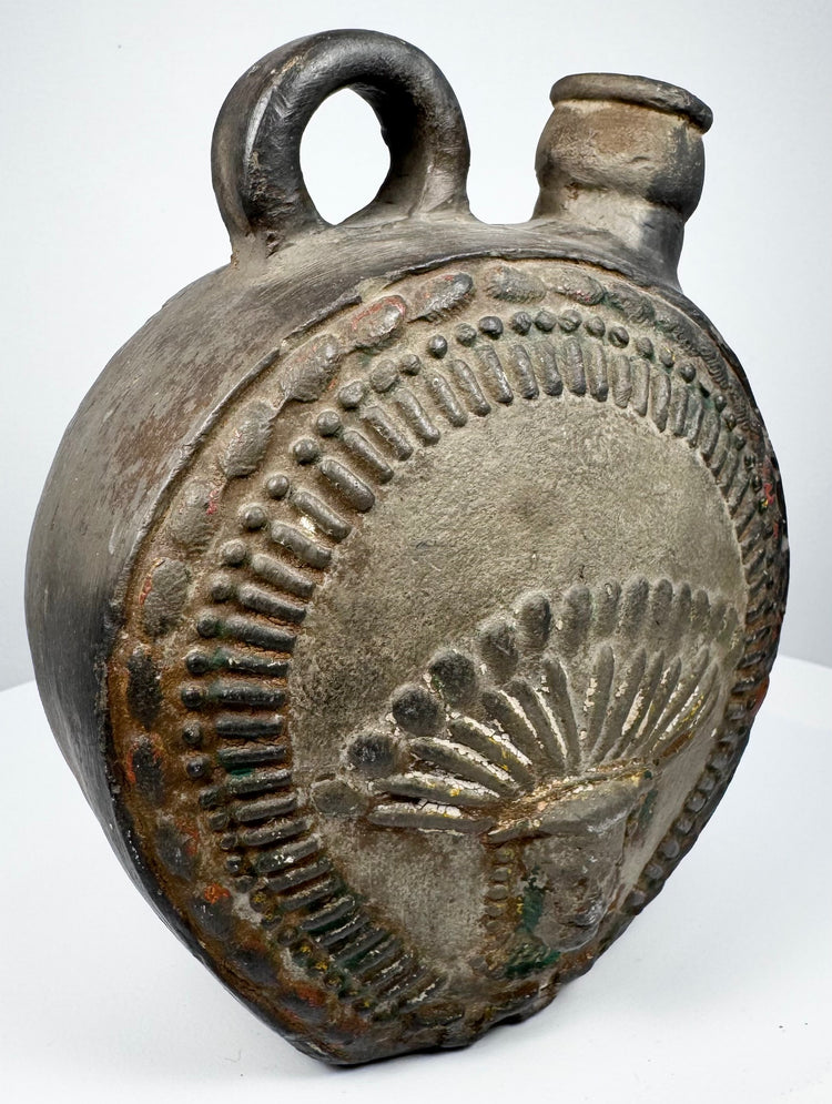 Pre-Columbian Andean flask with abstract relief motifs and worn ceramic surface