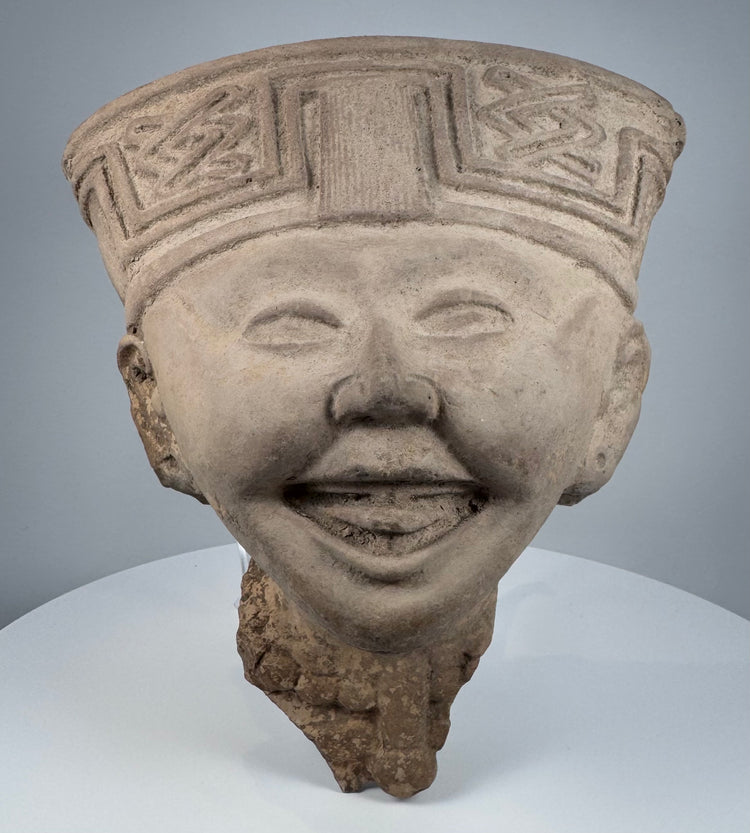 Ancient Mexican smiling face terracotta head from Veracruz with almond-shaped eyes and rounded cheeks