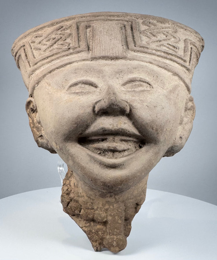 Pre-Columbian Veracruz ceramic head with broad open smile and ceremonial headdress decoration