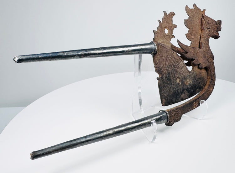 Indonesian iron and silver-covered nut cutter with flame-like crest and decorative cutting blade