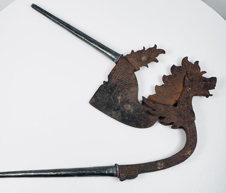 Decorative Indonesian betel nut cutter with dark iron patina, scrolling motifs and sculpted animal head