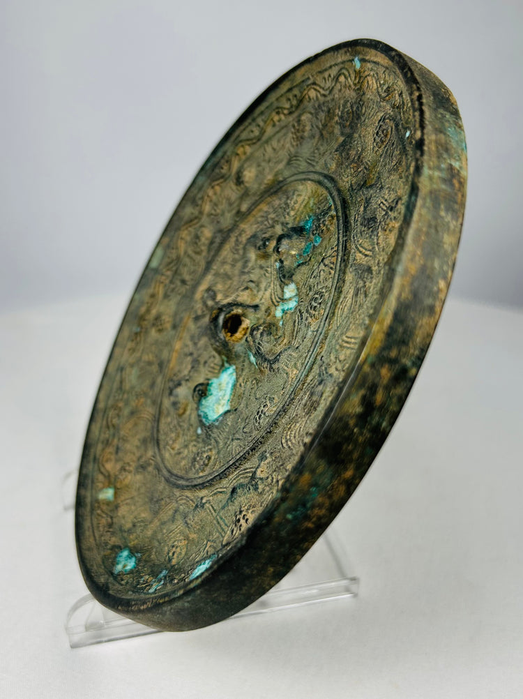 Antique Chinese bronze mirror with central suspension knob design