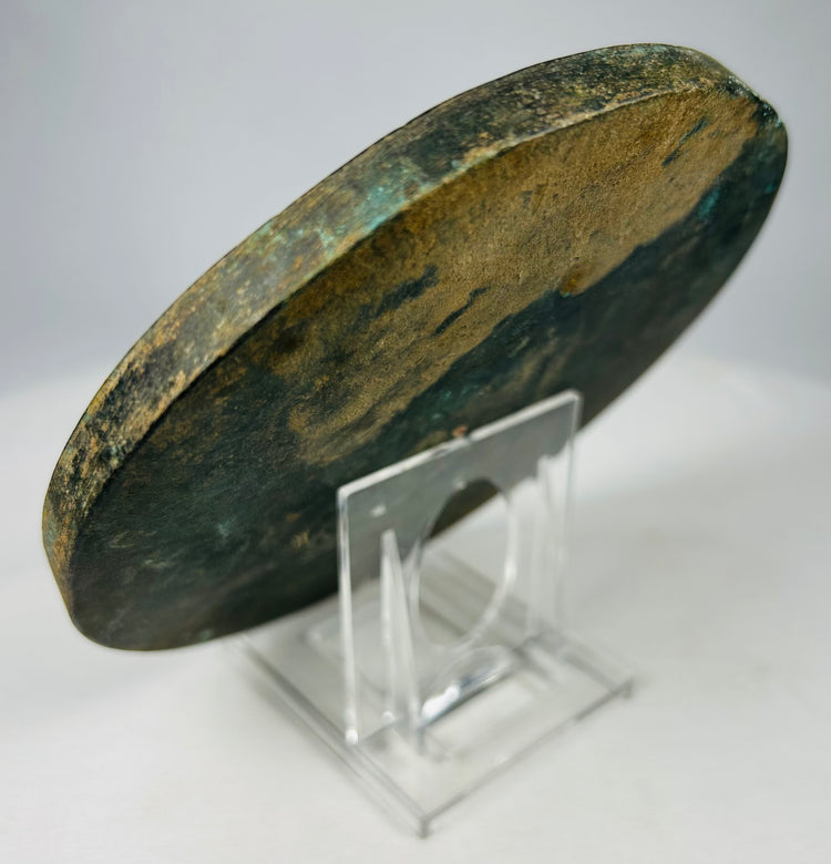 Chinese cast bronze mirror with concentric floral border patterns