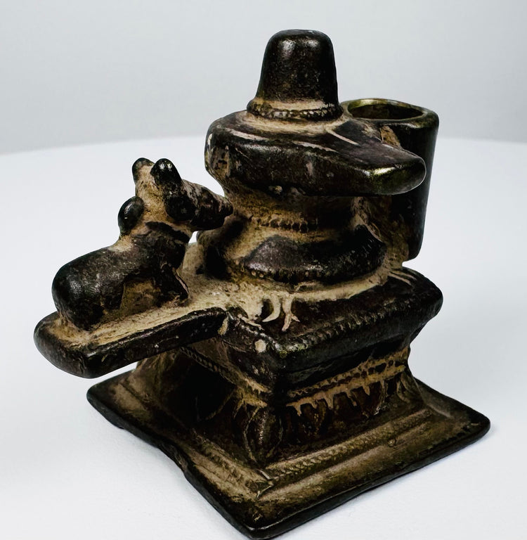 Small 19th century Indian brass Hindu shrine depicting Shiva Lingam and Nandi with historic patina.
