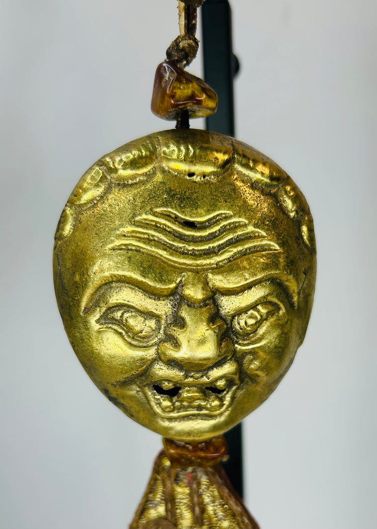 Himalayan gilt bronze ritual mask pendant with textile tassels