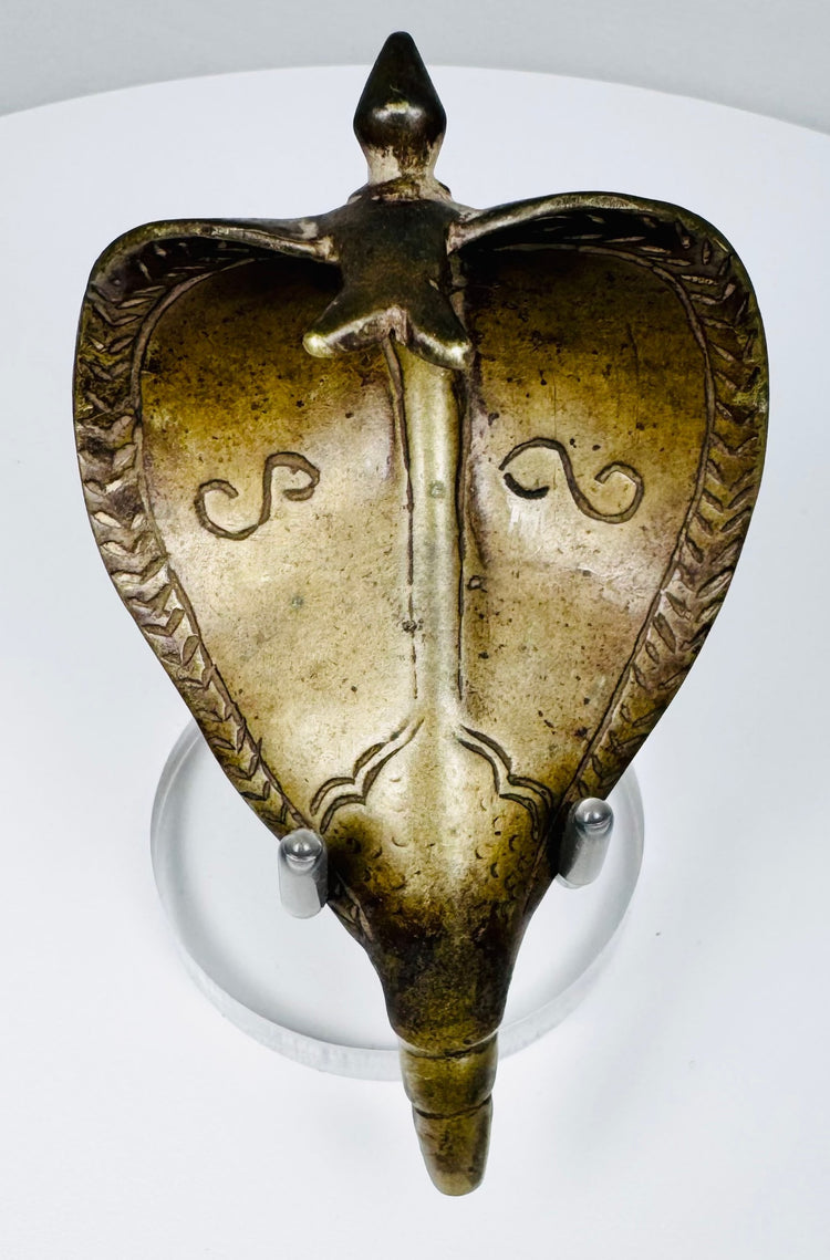 Indian cast brass Naga shrine element with expanded cobra hood and dark golden-brown patina.