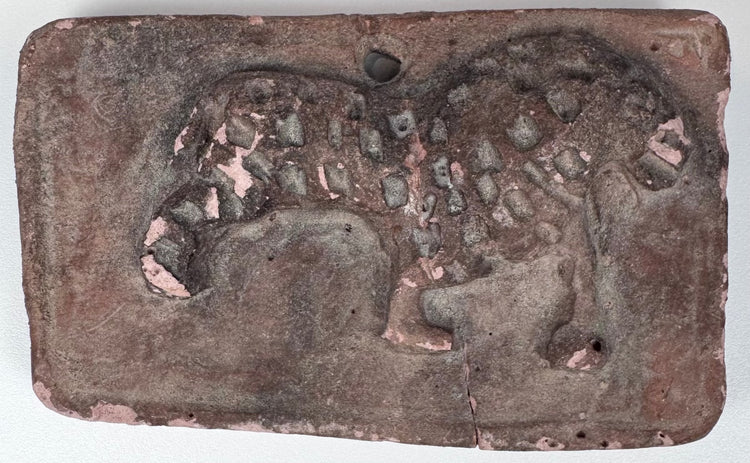 Early Indian moulded terracotta plaque featuring a large cat with curling tail and worn spotted decoration.
