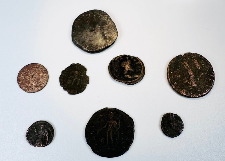 Selection of ancient copper-alloy and silver coins from the collection showing varied sizes, portraits and historic patinas.