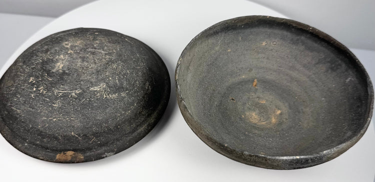 Ancient Chinese gray pottery covered bowl displayed open with lid and lower vessel side by side, showing the fitted two-part construction.