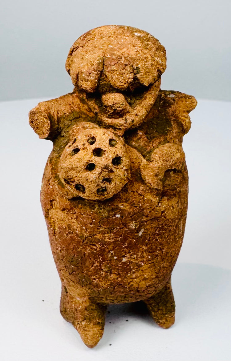 Rear view of Pre-Columbian Maya terracotta figural rattle showing headdress and firing aperture