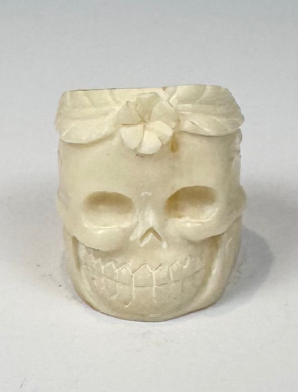 Memento mori-inspired camel bone ring with sculptural skull and foliate decoration