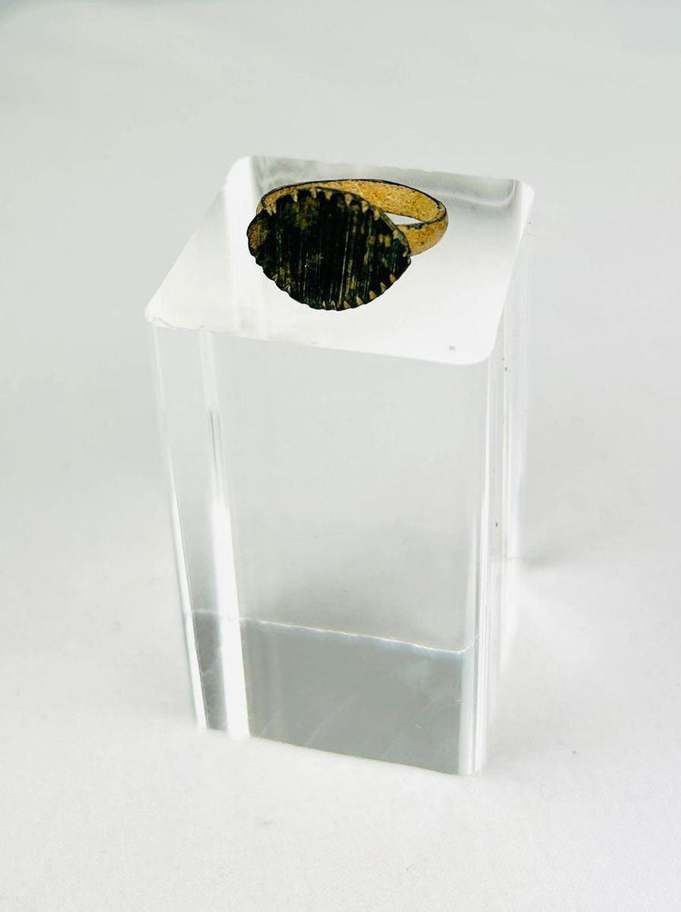 Imperial Roman bronze ring, circa 2nd–4th century AD, featuring incised linear decoration across its bezel; aged patina with green oxidation and surface wear from centuries of burial, historically used as both personal adornment and symbolic status marker within Roman society.