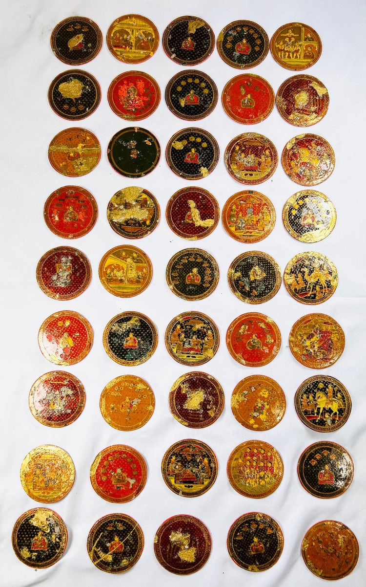 Collection of round painted Ganjifa cards displaying mythological scenes and gold leaf