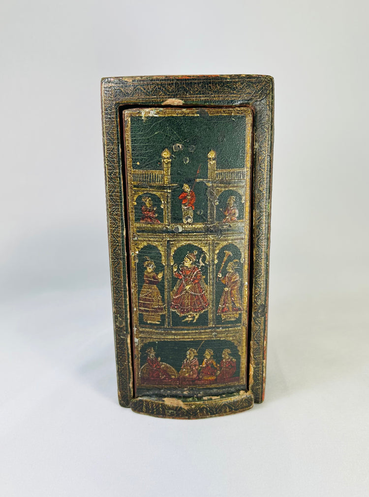 Complete 19th-century Indian Ganjifa set with 98 hand-painted round lacquered cards in paper-covered wood box decorated with polychrome palace, procession, and hunting scenes, cinnabar-red interior, reflecting South Asian miniature painting tradition.