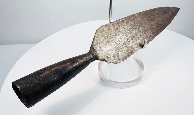 Detailed view of 18th-century forged iron spearhead showing patina, blade form and tapered socket