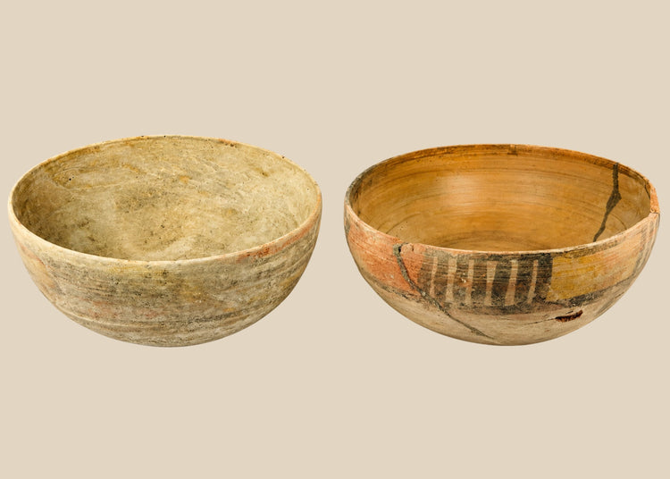 Two ancient Indus Valley terracotta bowls, circa 2nd–3rd millennium BCE; one plain with natural earthen patina, the other decorated with geometric polychrome painted motifs, both exhibiting age wear and archaeological restoration.