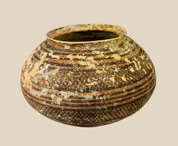Harappan terracotta vessel, 3rd millennium BCE, with bulbous body, narrow neck, and painted geometric designs in black and red-brown pigments.
