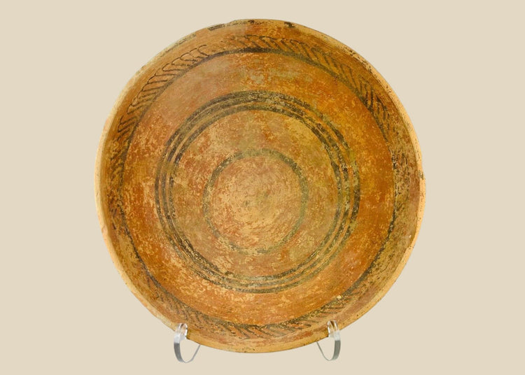 Indus Valley terracotta dish, 2nd millennium BCE, with painted concentric circles and geometric motifs in natural pigments, shallow ceremonial form.