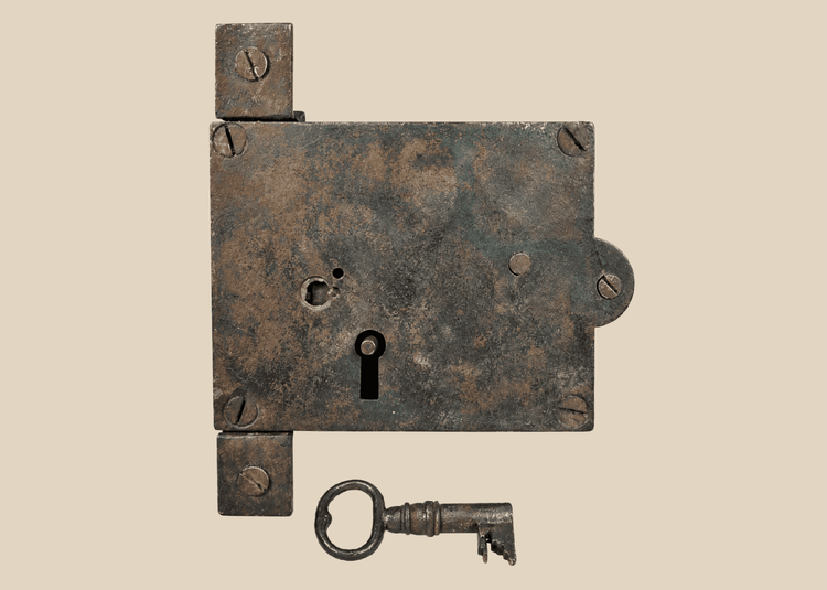 Antique 19th century iron rim lock with original skeleton key on display